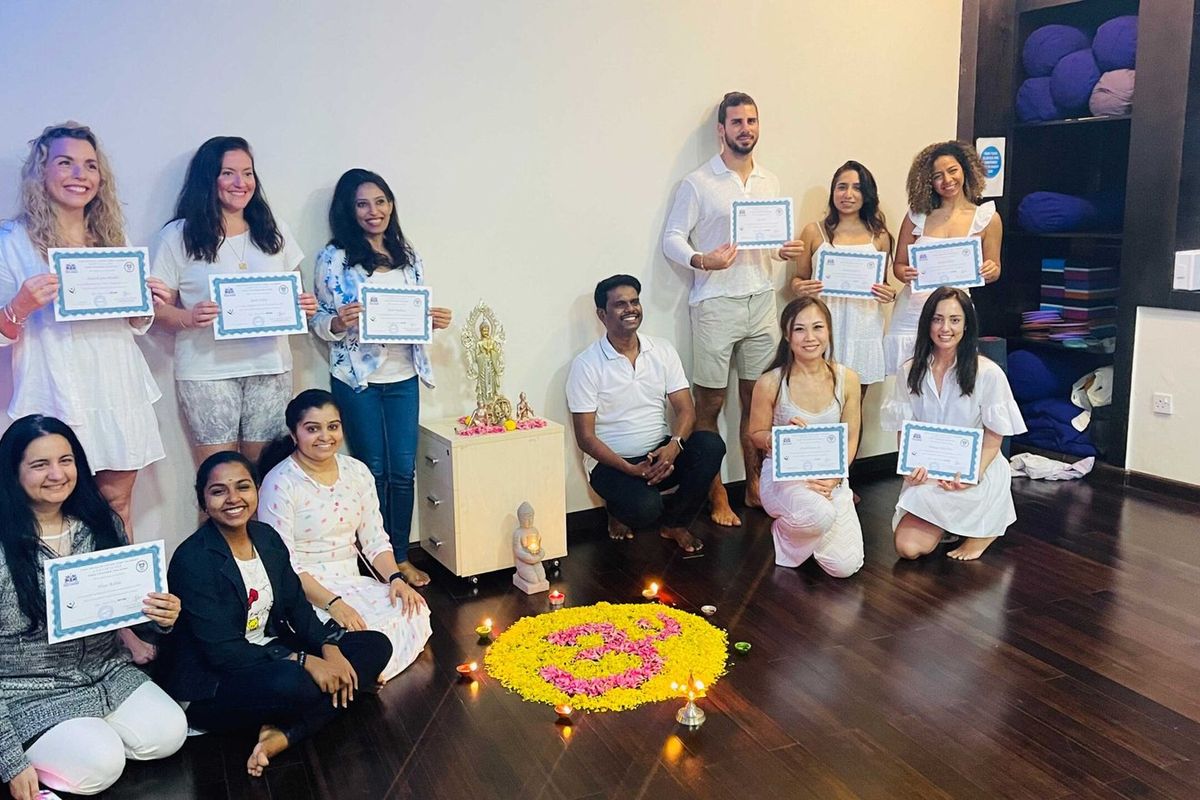 Yoga teacher training graduates with their certificates in Dubai