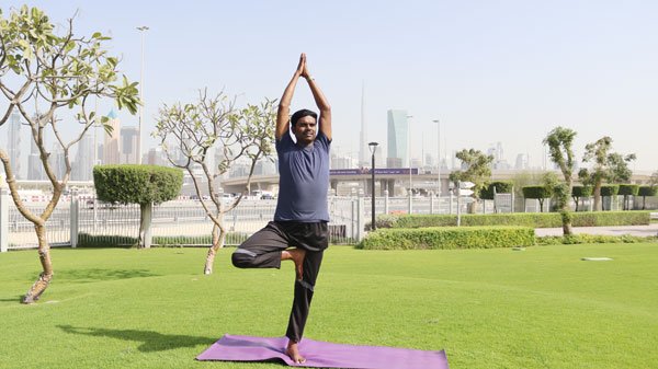 Yoga Teacher Training at Thousand Petaled Lotus Yoga Center in Dubai 1 Men and women practicing yoga in a well-lit studio at Thousand Petaled Lotus Yoga Center, Dubai